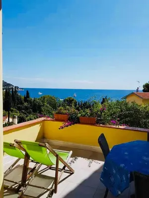 a balcony with chairs and a view of the ocean at Eze flat with terrace sea view and mountain view in Èze