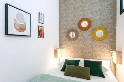 a bedroom with a bed and a wall with mirrors at L52 2BDR Massena central, 2 min from the beach AC in Nice