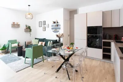 a kitchen and living room with a table and chairs at L52 2BDR Massena central, 2 min from the beach AC in Nice