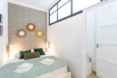 a bedroom with a bed with towels on it at L52 2BDR Massena central, 2 min from the beach AC in Nice