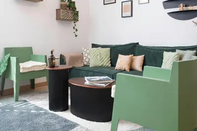 a living room with a green couch and a table at L52 2BDR Massena central, 2 min from the beach AC in Nice