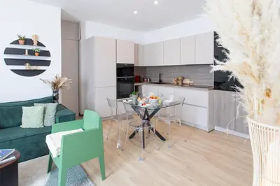 a kitchen and living room with a table and chairs at L52 2BDR Massena central, 2 min from the beach AC in Nice