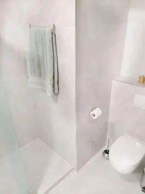 a white bathroom with a shower and a toilet at Chez L'Hadriana, 2x AC clim Wi-Fi,newly renovated in Nice