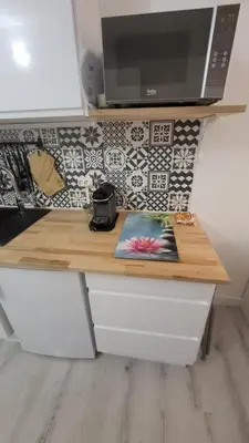 a wooden counter top with a microwave on top at Tournesol de Nice in Nice