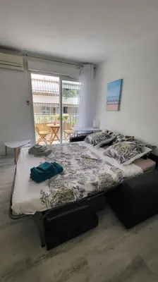 a bedroom with a bed and a window at Tournesol de Nice in Nice