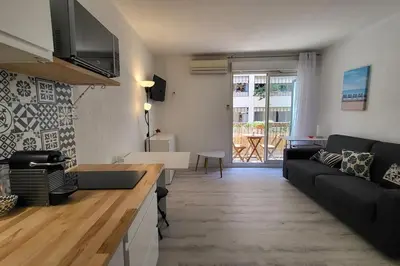 a living room with a couch and a table at Tournesol de Nice in Nice