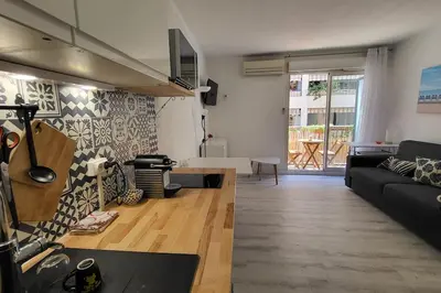 a living room with a couch and a table at Tournesol de Nice in Nice