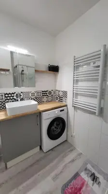 a kitchen with a washing machine and a sink at Tournesol de Nice in Nice