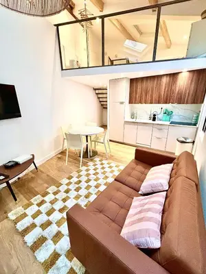 a living room with a couch and a table at Duplex moderne port de Nice in Nice
