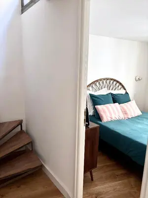 a bedroom with a bed with blue sheets at Duplex moderne port de Nice in Nice
