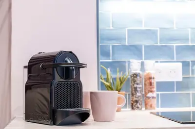 a coffee maker sitting on a counter next to a cup at Nice Renting - SPITALIERI - Chic & Cosy Art Deco Nest Nice Étoile in Nice