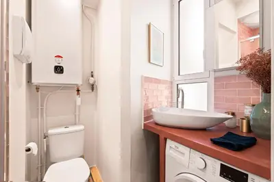 a bathroom with a sink and a toilet at Nice Renting - SPITALIERI - Chic & Cosy Art Deco Nest Nice Étoile in Nice