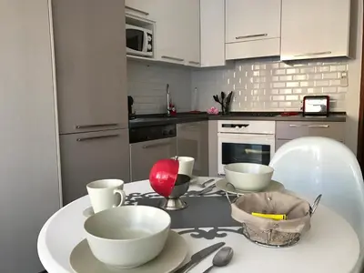 a kitchen with a table with three bowls on it at Royal Promenade in Nice