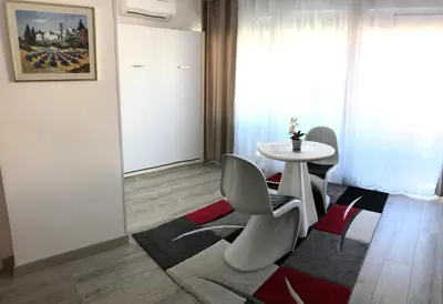 a living room with a white table and chairs at Royal Promenade in Nice