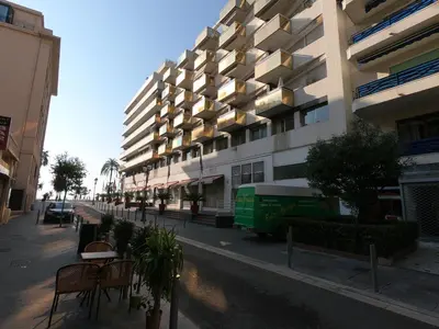 a building with a green van parked next to a street at Royal Promenade in Nice