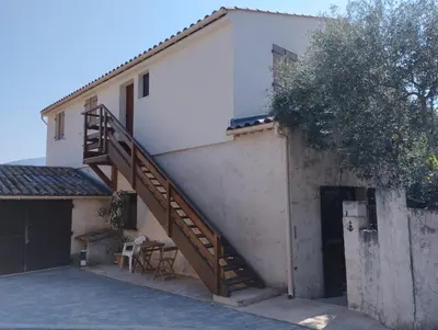 a house with a staircase on the side of it at entre terre et mer 3 pièces in Gattières