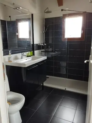 a bathroom with a sink and a toilet and a shower at entre terre et mer 3 pièces in Gattières