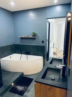 a bathroom with a white tub and a sink at Luxueux appartement, Carré d'Or, Square Mozart in Nice