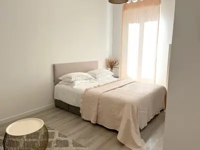 a white bedroom with a bed and a table at Shared Duplex Apartment Nice-Port in Nice