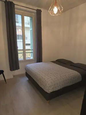 a bedroom with a bed and a window at Appartement cosy moderne calme hyper centre gare sncf in Nice