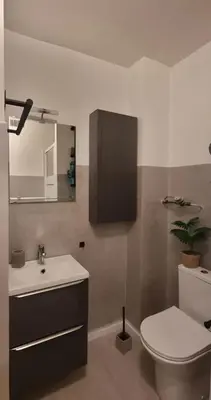 a bathroom with a sink and a toilet and a mirror at Appartement cosy moderne calme hyper centre gare sncf in Nice