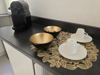 a kitchen counter with two bowls and plates on a table at Appartement cosy moderne calme hyper centre gare sncf in Nice