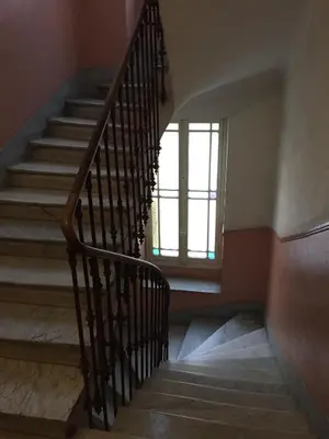 a staircase in a house with a window at Appartement le Fighiéra in Nice