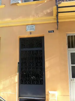 a black door on the side of a building at Appartement le Fighiéra in Nice