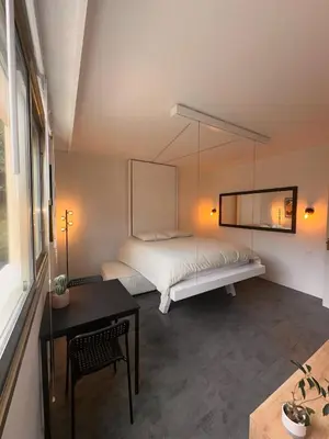 a bedroom with a large bed and a table at Beau studio au cœur de Beaulieu-sur-mer in Beaulieu-sur-Mer