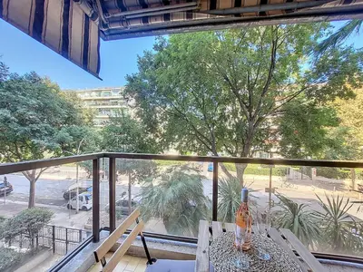 a balcony with a table and a view of a street at Nestor&Jeeves - KALLISTA - Central - Balcony in Nice