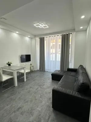 a living room with a couch and a table at Appartement 3 pieces proche du Negresco in Nice