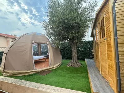 a chair sitting on a deck next to a house at Glamping Dôme in Cagnes-sur-Mer