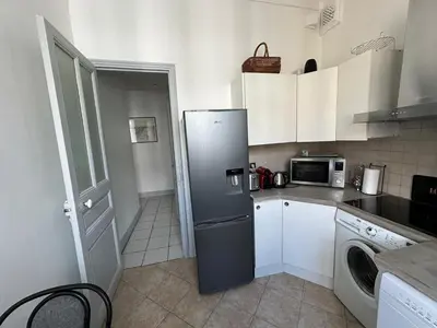 a kitchen with a refrigerator and a microwave at Beau T2 proche Negresco in Nice