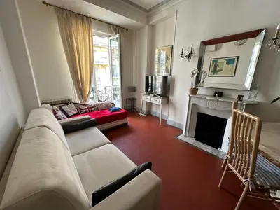 a living room with a couch and a fireplace at Beau T2 proche Negresco in Nice