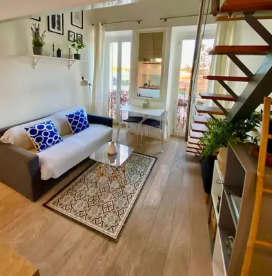 a living room with a couch and a table at Superbe Duplex avec vue ! in Villefranche-sur-Mer