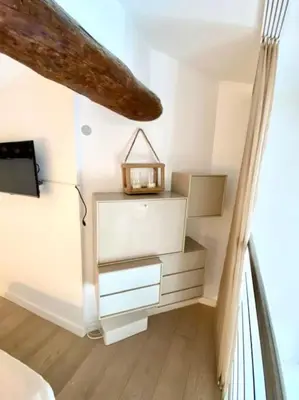a room with a dresser with a clock on it at Superbe Duplex avec vue ! in Villefranche-sur-Mer