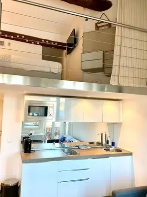 a kitchen with white cabinets and a sink at Superbe Duplex avec vue ! in Villefranche-sur-Mer