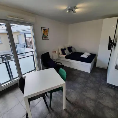a bedroom with a bed and a desk and a table at Ma place au sud Nice 607 in Nice