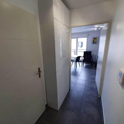 a hallway with a door to a room with a table at Ma place au sud Nice 607 in Nice