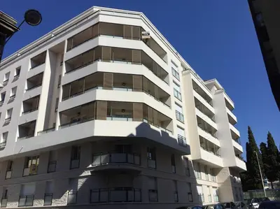 a tall white building with a lot of windows at Ma place au sud Nice 607 in Nice