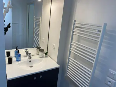a bathroom with a sink and a mirror at Ma place au sud Nice 607 in Nice