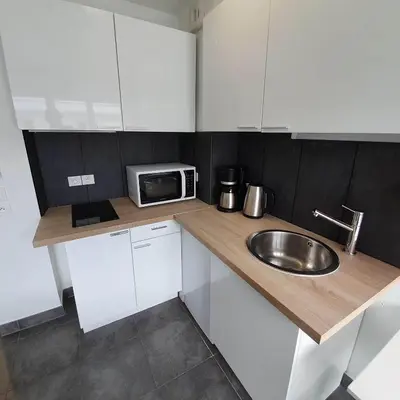 a small kitchen with a sink and a microwave at Ma place au sud Nice 607 in Nice