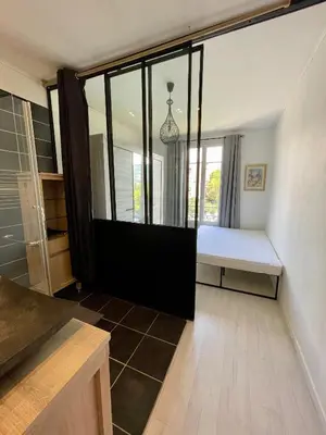 a bedroom with a bed and a large window at Spacieux appartement à Nice in Nice