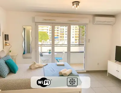 a bedroom with a bed and a view of a balcony at Ma place au sud Nice 405 in Nice