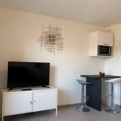 a living room with a flat screen tv on a wall at Ma place au sud Nice 405 in Nice