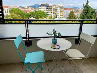 a white table and two chairs on a balcony at Ma place au sud Nice 405 in Nice