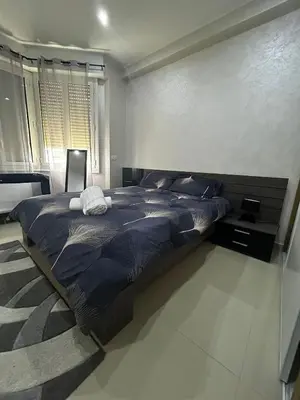 a bedroom with a bed with a blue comforter at Sea Front View - FRONT DE MER ET VUE PANORAMIQUE in Nice