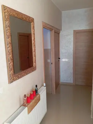 a bathroom with a mirror and red candles on a shelf at Sea Front View - FRONT DE MER ET VUE PANORAMIQUE in Nice