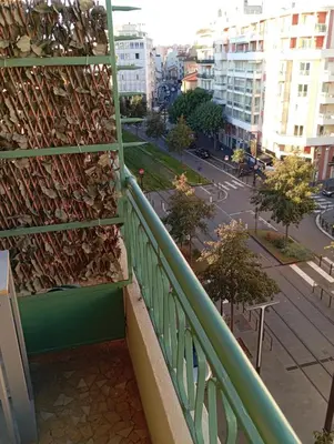 a balcony with a bunch of shoes on a wall at Sea Front View - FRONT DE MER ET VUE PANORAMIQUE in Nice