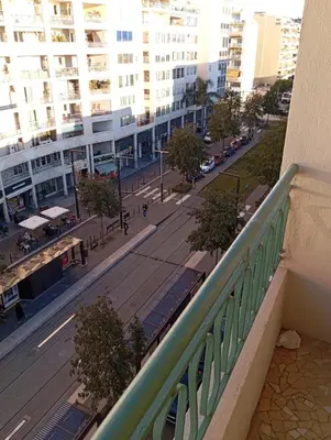a balcony with a view of a street and buildings at Sea Front View - FRONT DE MER ET VUE PANORAMIQUE in Nice